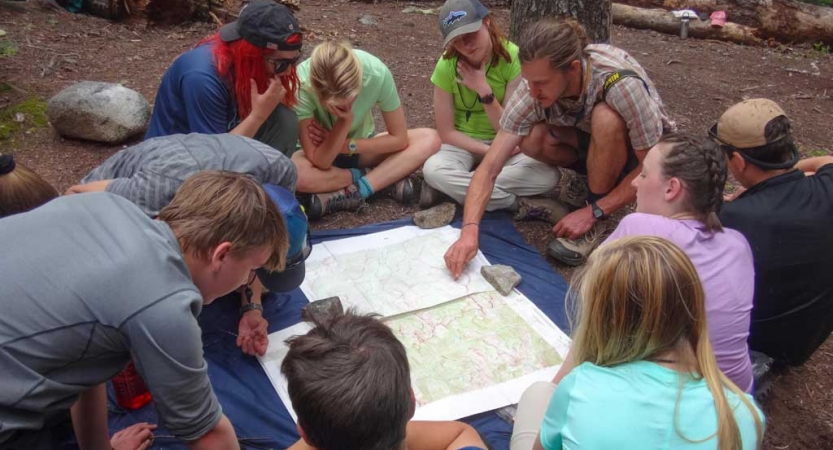 teens learning navigation on backpacking trip